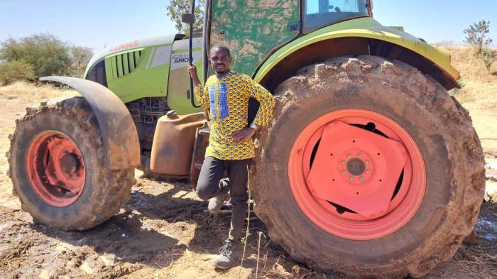Photo of Dieudonne Ilboudo in front of a tractor