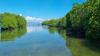 Photo of the sea in front of Lombok with two islands to the left and right full of mangroves